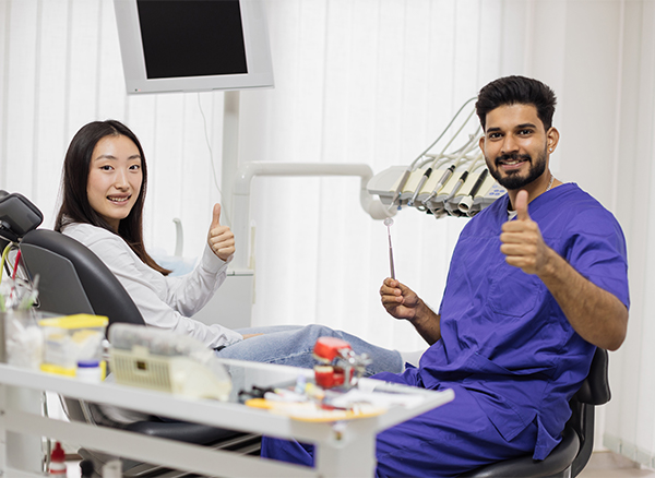 Patient and Dentist doing a thumbs up