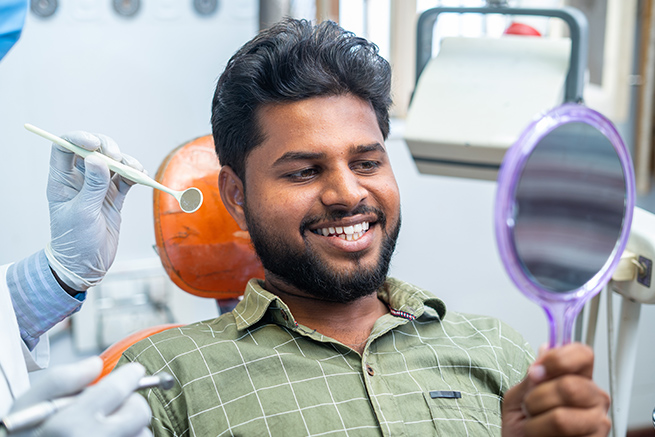 Person checking his new cleaned teeth